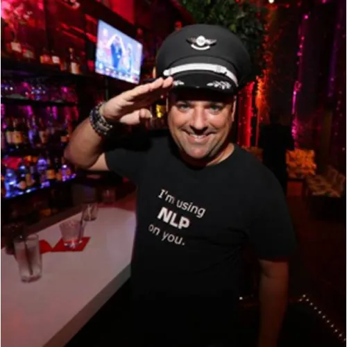 A member in a pilot cap at a cocktail party