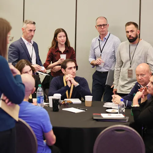 Members standing together at a table