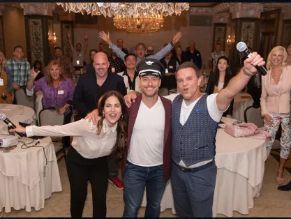 Members cheering together in a ballroom