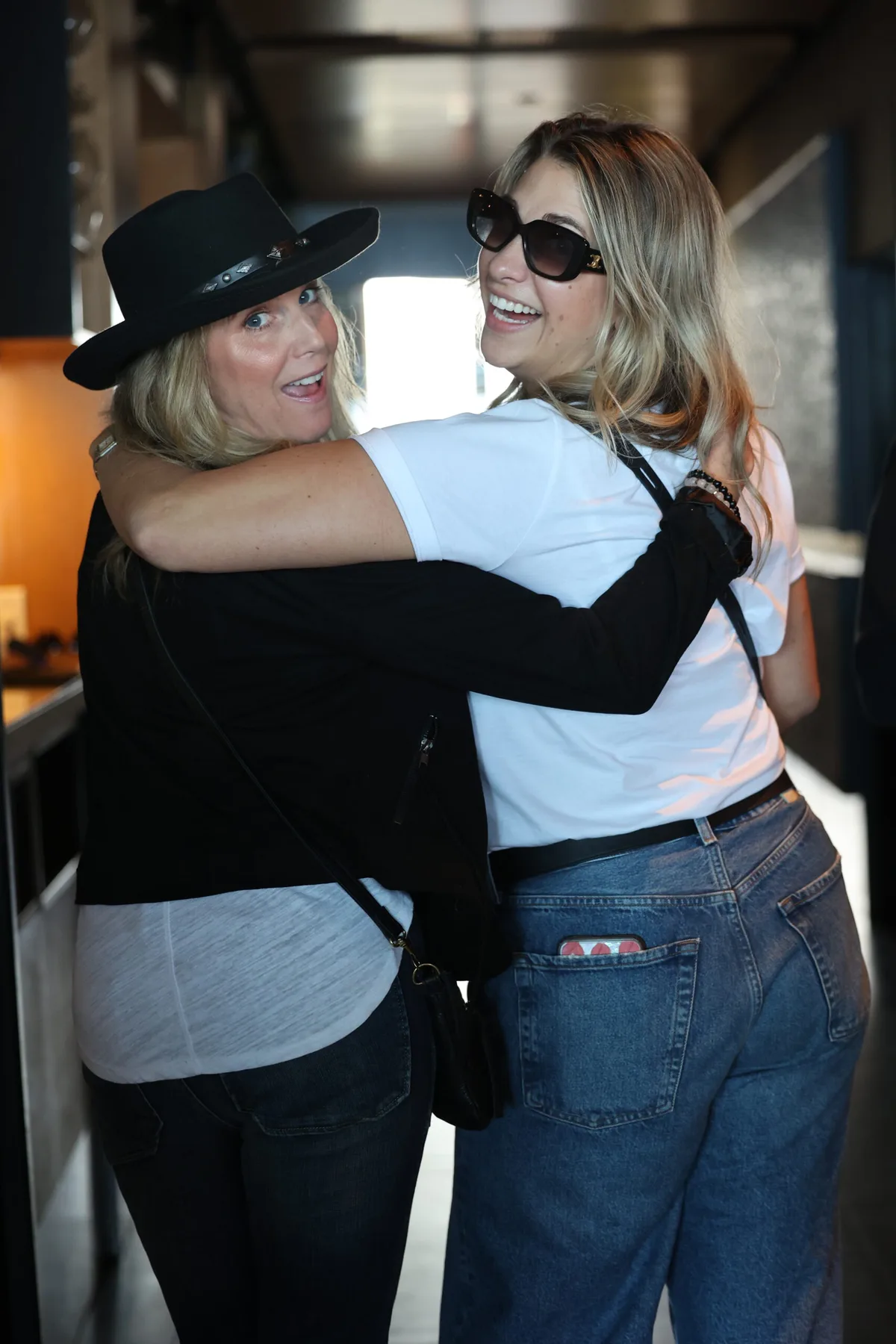 Two members greeting each other with a hug