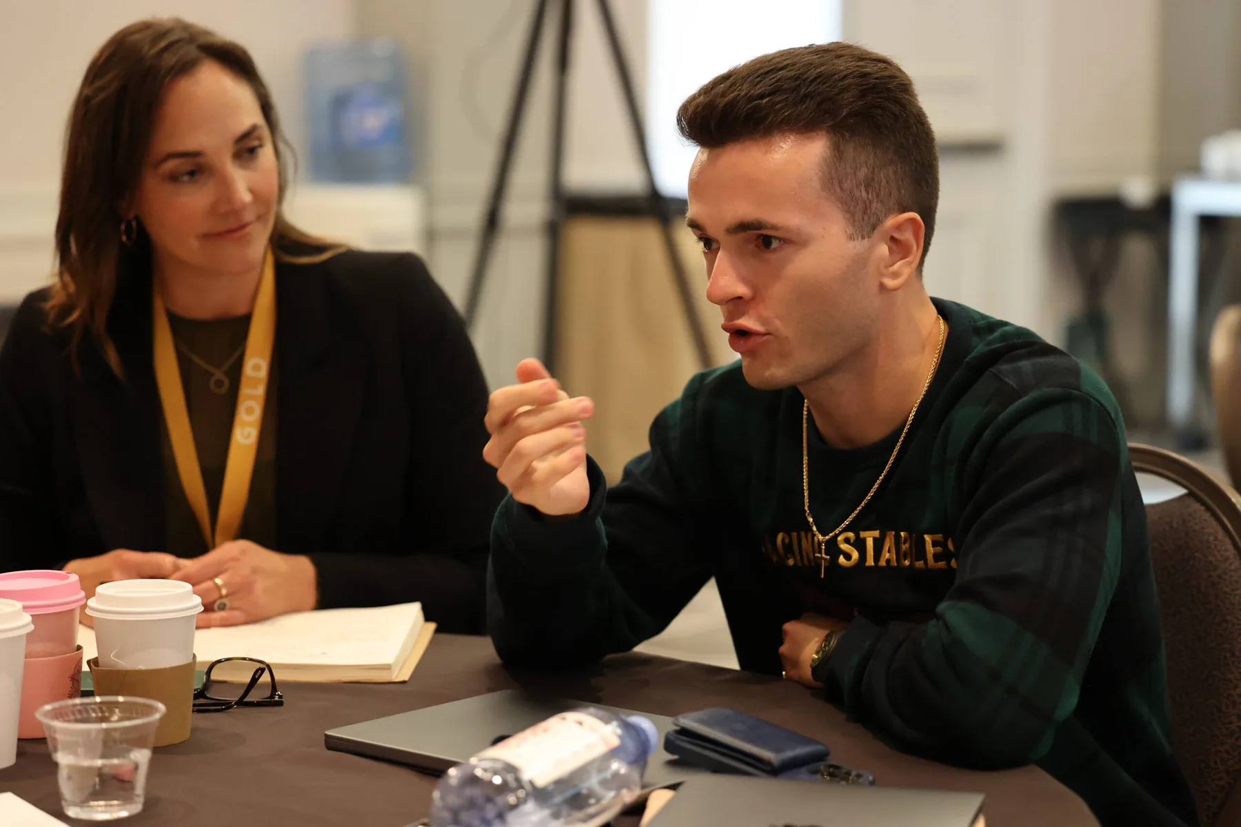 Two members in a focused conversation across a table