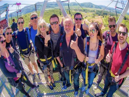 A group of members in harnesses on an outdoor adventure
